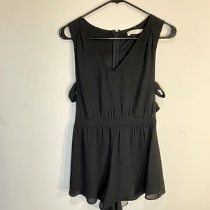 Francesca’s Collections Black romper with side cutouts size Medium